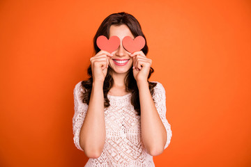 Wall Mural - portrait of positivce cheerful girl hold red little paper card heart hide her eyes play with boyfrie