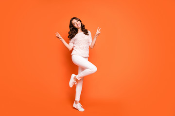 Wall Mural - Full length photo of charming girl have summer free time make v-sign enjoy holidays wear good looking outfit isolated over orange color background