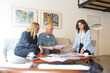 © Mangostar - Middle aged couple meeting with interior designer to discuss renovation project. Man and women sitting in living room at home and talking. Designer occupation concept