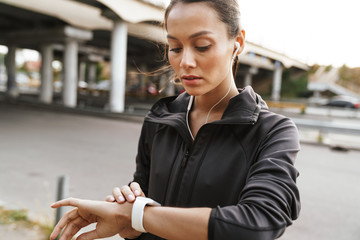 Poster - Sports concentrated woman looking at watch clock