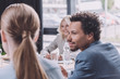 © LIGHTFIELD STUDIOS - selective focus of young african american businessman looking at colleague during business meeting