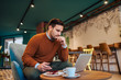 © bnenin - Serious entrepreneur looking at laptop while sitting in beautiful cafe.