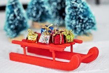 Red Miniature Sled (sleigh) With Gifts And Presents On It. Wonderful Christmas Concept