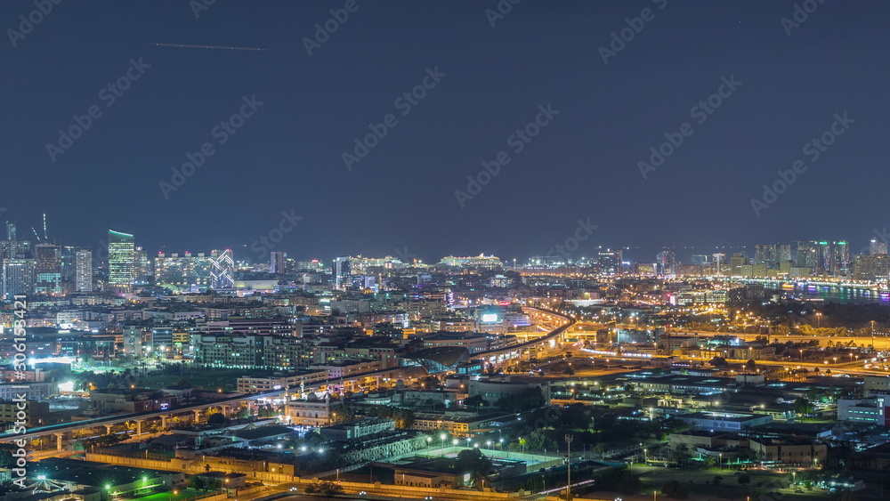 The rhythm of the city at night with illuminated road in Dubai near canal aerial timelapse - obrazy, fototapety, plakaty 