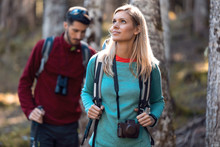 Two Travel Hikers With Backpack Walking While Looking The Landscape In The Forest.