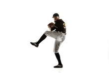 Baseball Player, Pitcher In A Black Uniform Practicing And Training Isolated On A White Background. Young Professional Sportsman In Action And Motion. Healthy Lifestyle, Sport, Movement Concept.