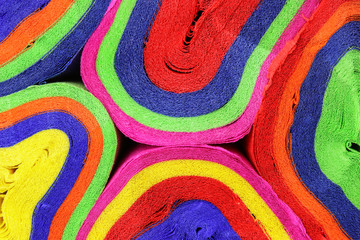  Close up coils of colorful crepe paper bunting of red, orange, yellow, green, blue and pink to make an abstract background