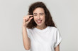© fizkes - Smiling millennial girl show small measurement with hands