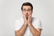 © fizkes - Millennial Caucasian man in glasses feel astonished or shocked