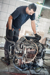 Wall Mural - Removed engine from car. Auto mechanic repairs car engine