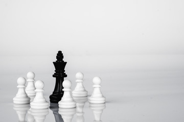 King is in trouble, surrounded by the enemies. Business strategy and competition concept. Black and White.