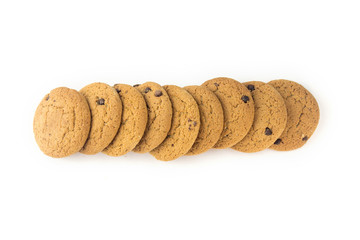 Homemade cookies with chocolate laid out in a horizontal line on an isolated light background..