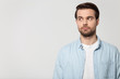 © fizkes - Serious Caucasian man look aside at blank copy space