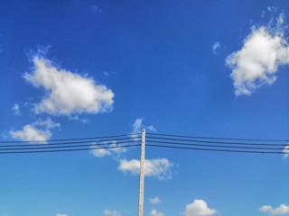 Light pole set on a bright sky background with thin clouds