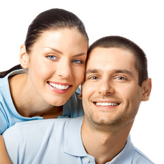 Portrait of young happy smiling lovely couple, isolated over white background