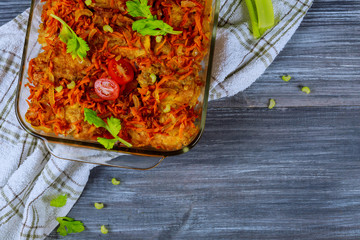 Wall Mural - Fried crucian fish in a glass pan on a rustic table