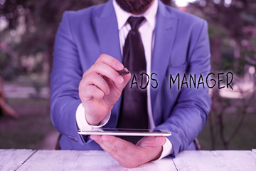 Writing note showing Ads Analysisager. Business concept for oversee and control the various advertising activities Businessman pointing with pen in empty copy space