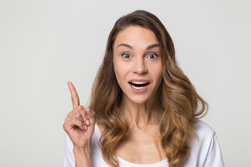 Wall Mural - Smiling excited woman finger up gesture, good new idea