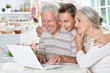 © aletia2011 - Portrait of happy senior couple with grandson using laptop at home