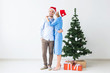 © satura_ - Holidays and celebration concept - Young couple celebrating Christmas at home