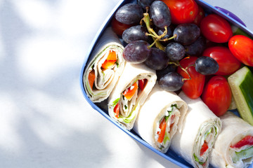 Wall Mural - Lunch box with tortilla wraps, fruits and vegetables. Healthy eating concept.