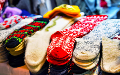 Sticker - Socks made from wool at stalls during Christmas Market in Riga, Latvia in winter. Street Xmas and holiday fair in European city or town. Advent Decoration with Crafts Items on Bazaar