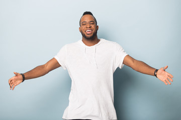 Wall Mural - Happy friendly African American man raising hands, offering hugs