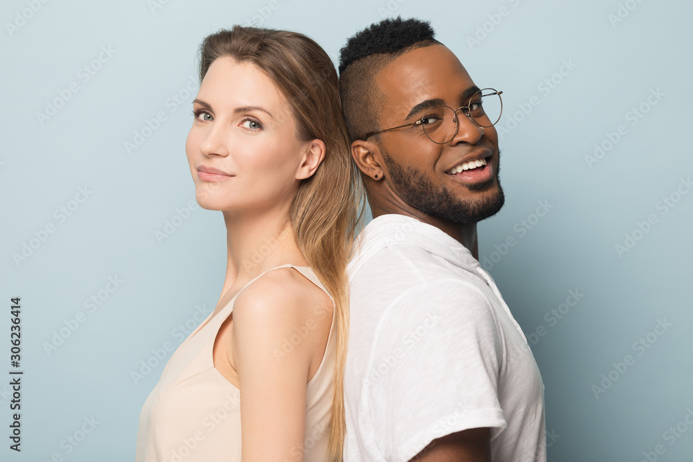 Smiling African American man and woman standing back to back Stock ...