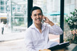 © BullRun - Asian businessman talking on phone