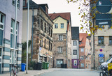 Fototapeta  - Furth, Germany, 21 November 2019: view of one of the city streets. 19th century houses with multi-colored facades. Bicycle parking. Garbage bins.