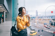 © BullRun - Young thoughtful Asian woman with coffee looking at panoramic window