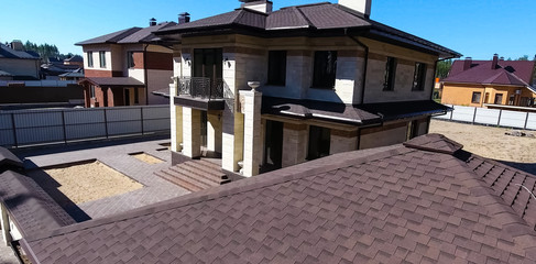 Bituminous tile for a roof. House with a roof from a bituminous tile. a roof from a bituminous tile. Moder