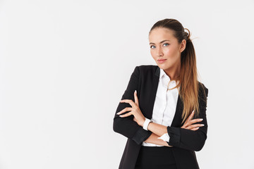 Wall Mural - Photo of young businesswoman looking at camera with arms crossed