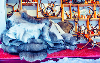 Poster - Market stall with traditional souvenirs such as reindeer skin and horns in winter Rovaniemi Finland in Lapland in winter. Street Xmas holiday fair. Advent Decoration and Stalls with Crafts on Bazaar