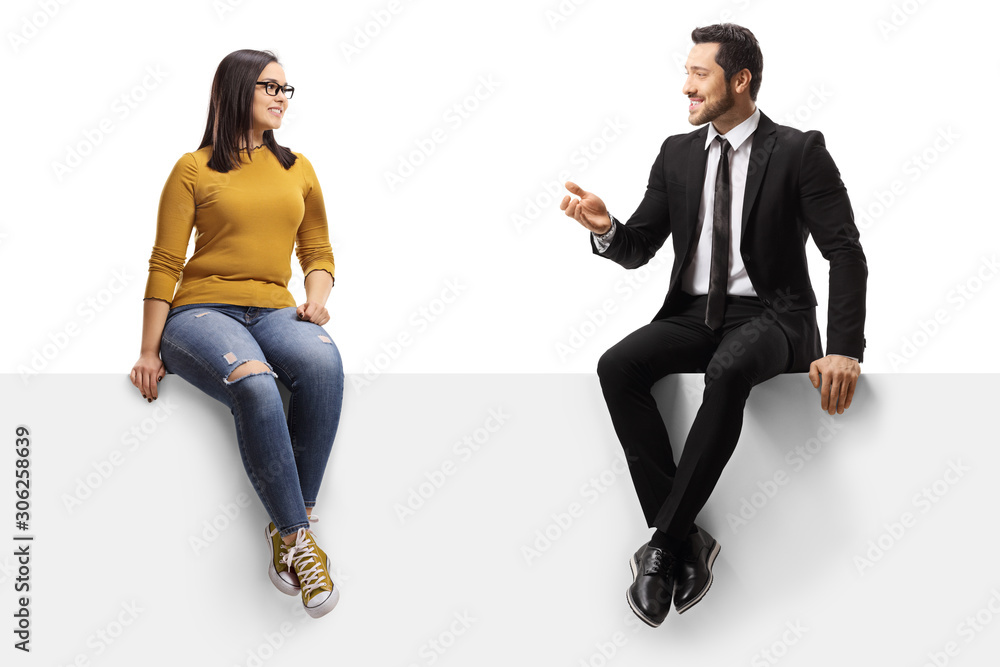 Businessman talking to a young female and sitting on a panel - obrazy, fototapety, plakaty 