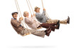 Happy senior people swinging on swings