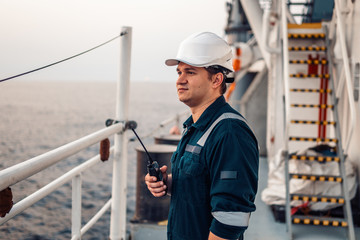 marine deck officer or chief mate on deck of offshore vessel or ship , wearing ppe personal protecti