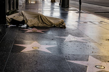Homeless Man Sleeping On The Famous Street Of  Hollywood