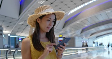 Wall Mural - Woman check on cellphone in the airport