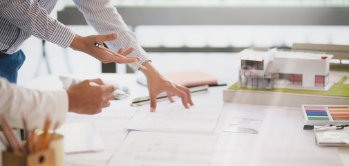 cropped shot of young professional architect team working on their project together in modern office