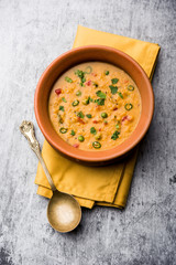 Wall Mural - Vegetable masala oats khichadi served in a bowl. selective focus