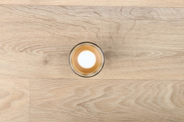 Macchiato Coffee Cup - Coffee in a black cup isolated on a wooden background - Cappuccino Latte Espresso   