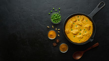 Cooking Tasty Chicken Curry In Pan On Black Background. Flat Lay, Top View With Copy Space