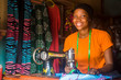 © Confidence - portrait of a pretty young african woman who is a tailor smiling