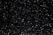 Falling  Snow At Night. Bokeh Lights On Black Background, Flying Snowflakes In The Air. Overlay Texture. Snowstorm