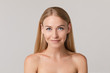© Вячеслав Косько - Medium close-up portrait of beautiful young European woman isolated at white studio background. Charming smiling naked female with long blonde hair looking at camera having positive emotion