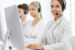 © Iryna - Call center. Group of operators at work. Focus on beautiful woman receptionist in headset at customer service white colored office. Business concept