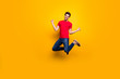 © deagreez - Full size photo of cheerful content guy jump win lottery raise fists wear casual style clothes isolated over yellow color background