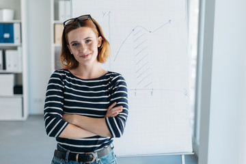 Wall Mural - Confident modern young businesswoman in an office