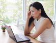 © Phuttharak - Beautiful asian woman sitting alone in coffee shop with computer on table ,